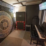 Somni Studios 4 Square Room with custom acoustic treatment, keyboard, and screen for recording and video sessions
