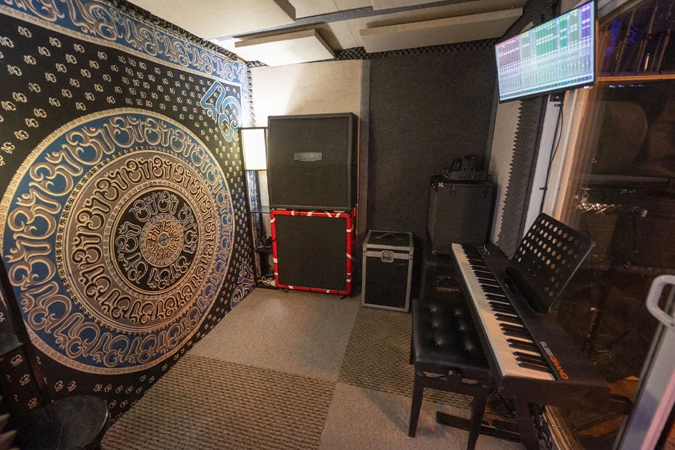 Somni Studios 4 Square Room with custom acoustic treatment, keyboard, and screen for recording and video sessions