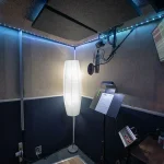 Somni Studios Diamond Room vocal booth with microphone, music stand, and acoustic treatment for vocal and voice over recording