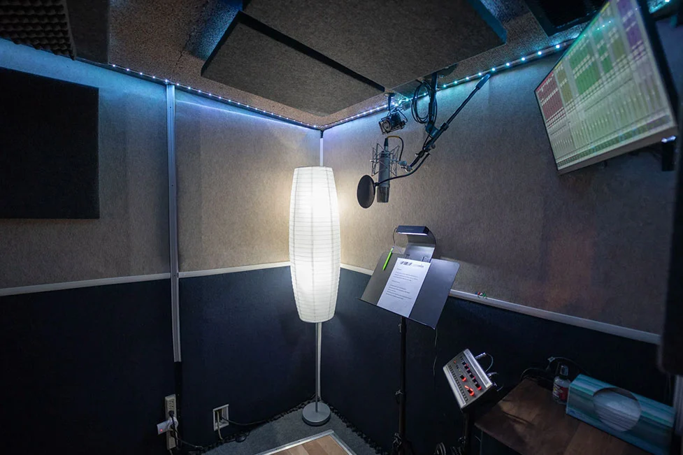 Somni Studios Diamond Room vocal booth with microphone, music stand, and acoustic treatment for vocal and voice over recording