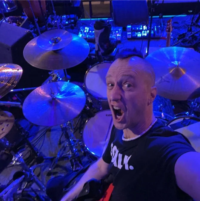 Matthew Fletcher playing drum kit during live performance representing Somni Studios musician and engineer experience