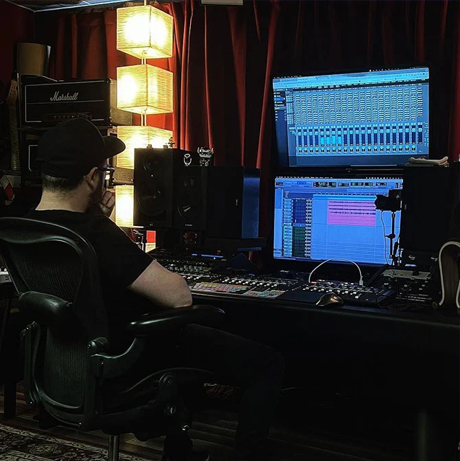 Scot Baber working at mixing console in Somni Studios control room during audio project
