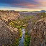 Clear river winding through trees and rocky canyon near Prineville Oregon