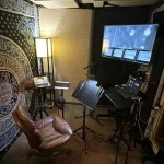 ADR recording booth with screen, mic, and seating at Somni Studios.