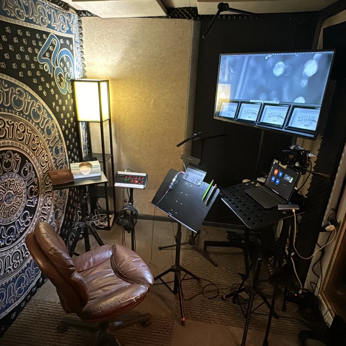 ADR recording booth with screen, mic, and seating at Somni Studios.