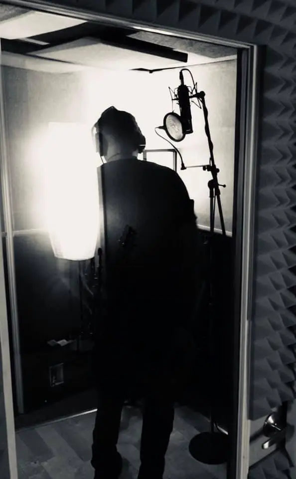 Voice actor recording ADR session in Somni Studios booth.