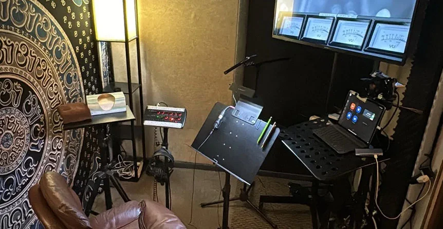 Acoustically treated ADR and voice over booth at SOMNI Studios with microphones and monitors for film and commercial recording