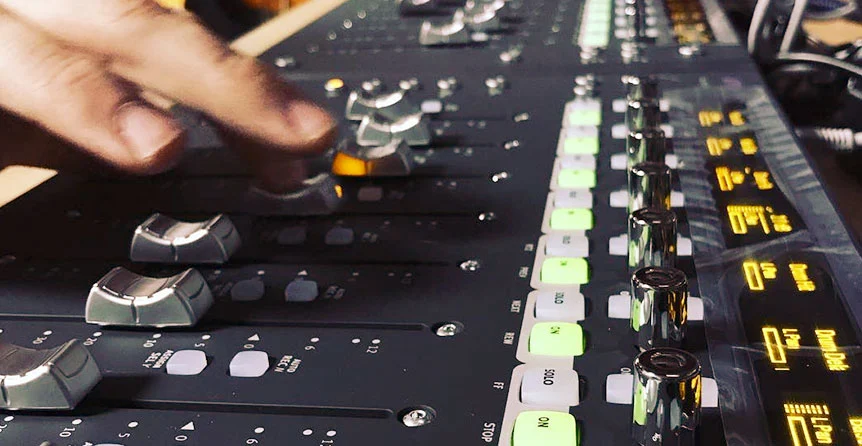 SOMNI Studios engineer adjusting analog and digital mixing console with modern plugins for high-quality audio mixing