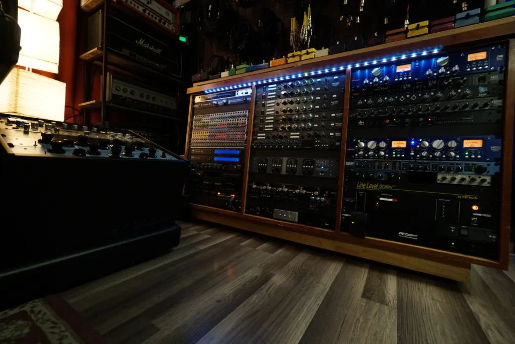 Analog rack gear with compressors, EQ, and preamps at Somni Studios.