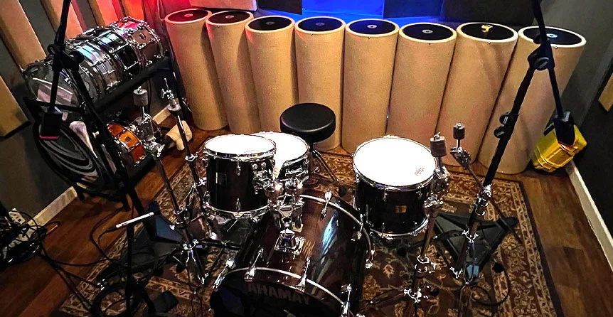 Drum kit setup in SOMNI Studios live recording room with multiple microphones for professional multi-track recording in Central Oregon