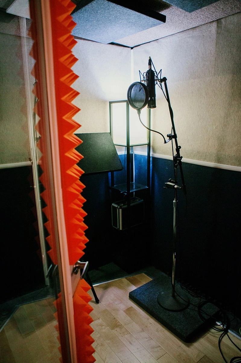 Voice over booth with microphone and acoustic treatment at Somni Studios.