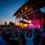 Crowd enjoying Trombone Shorty concert in Bend Oregon under vibrant lights