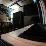 Angled view of SL88 Grand keyboard inside Somni Studios sound booth.