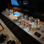 Avalon Design tube preamp glowing blue in the Somni Studios rack setup.