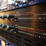 Compressor and limiter rack with illuminated level indicators at Somni Studios.