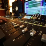 Detail view of mixing console and Pro Tools meters at Somni Studios.