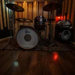 Corner view of the Somni Studios Live Room showing drums and acoustic panels.