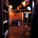 Wide-angle shot of the Somni Studios Live Room with drum kit and acoustic treatment.