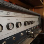 Vintage Sears Silvertone amplifier with aged metal panel at Somni Studios.