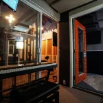 View from Somni Studios sound booth window into recording area.