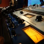 Vintage tube compressor with illuminated VU meters at Somni Studios.