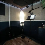 Voice-over booth at Somni Studios with pop filter and lighting setup.
